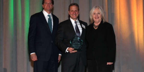 PMC Property Group President Ron Caplan (center) accepts an award for Best Mixed Use Project of 2011