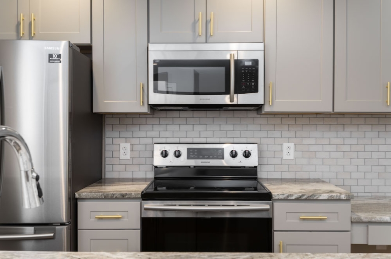 Waterfront Apartments' kitchen featuring granite countertops and stainless steel appliances