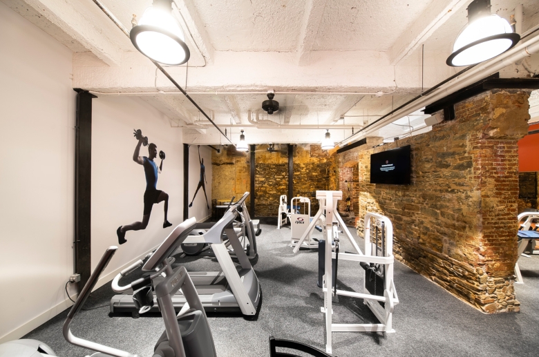 fitness center with exposed brick wall