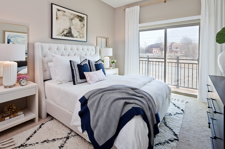 Bedroom features floor-to-ceiling windows