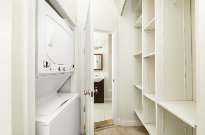 In-unit laundry space with built-in shelving