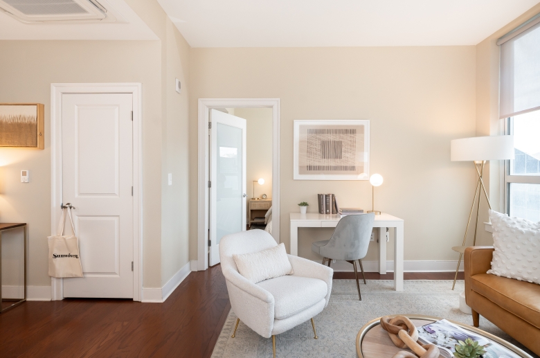 Model living room with main bedroom in background